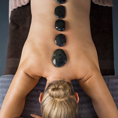 female client is taking hot stone massage at maahru massage center in Karachi